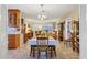 Inviting dining area with an adjoining living space, wooden cabinetry, and tile flooring for easy maintenance at 3151 Datura Rd, Venice, FL 34293