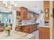 Well-lit kitchen and dining area with wooden cabinetry, neutral walls, and a clean, functional design at 3151 Datura Rd, Venice, FL 34293