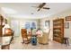 Comfortable living area showcasing tile flooring, a ceiling fan, and cozy furnishings perfect for relaxation and entertaining at 3151 Datura Rd, Venice, FL 34293