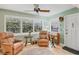 Relaxing sunroom with multiple windows, ceiling fan, and comfortable seating at 3151 Datura Rd, Venice, FL 34293