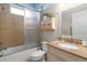 Clean bathroom with tub, shower, and granite vanity at 320 Langholm Dr, Venice, FL 34293
