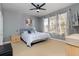 Spacious bedroom with striped bedding and large windows at 320 Langholm Dr, Venice, FL 34293