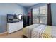 Bright bedroom with a comfy bed, dresser, and large window at 320 Langholm Dr, Venice, FL 34293