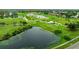 Aerial view of a lush green golf course with ponds at 320 Langholm Dr, Venice, FL 34293