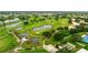 Aerial view of a scenic golf course with ponds and homes at 320 Langholm Dr, Venice, FL 34293