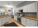 Modern kitchen with stainless steel appliances and granite countertops at 320 Langholm Dr, Venice, FL 34293