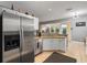 Kitchen with corner sink, island, and stainless steel refrigerator at 320 Langholm Dr, Venice, FL 34293