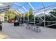 Relaxing screened lanai with hot tub, fire pit, and seating area at 320 Langholm Dr, Venice, FL 34293