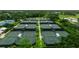 Aerial view of eight well-maintained tennis courts at 320 Langholm Dr, Venice, FL 34293