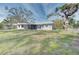 Large backyard with a spacious house and mature trees at 324 Monet Dr, Nokomis, FL 34275