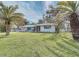 Newly renovated home with a spacious lawn and palm trees at 324 Monet Dr, Nokomis, FL 34275