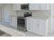 Modern kitchen with stainless steel appliances and white cabinets at 324 Monet Dr, Nokomis, FL 34275