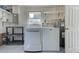 Laundry room with washer, dryer, and ample shelving at 324 Monet Dr, Nokomis, FL 34275