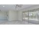 Spacious living area showcasing sliding glass doors and tile floors at 324 Monet Dr, Nokomis, FL 34275