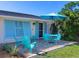 Inviting patio with teal furniture and umbrella at 329 Coral St, Venice, FL 34285