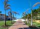 Brick walkway leading to the beach with palm trees lining the path at 329 Coral St, Venice, FL 34285