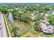 Aerial view of waterfront homes and lush landscaping at 335 Pembroke S Ln # 229, Venice, FL 34293