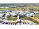 Aerial view of clubhouse, pool, and landscaping at 335 Pembroke S Ln # 229, Venice, FL 34293