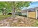 Backyard view showcasing mature trees and home exterior at 335 Pembroke S Ln # 229, Venice, FL 34293