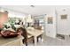 Bright dining room with a chandelier and wicker chairs at 335 Pembroke S Ln # 229, Venice, FL 34293