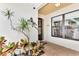 Front entry with tiled flooring and tropical plants at 335 Pembroke S Ln # 229, Venice, FL 34293