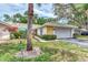 Single-story home with attached garage and well-manicured lawn at 335 Pembroke S Ln # 229, Venice, FL 34293