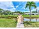 Wooden footbridge over canal leading to community at 335 Pembroke S Ln # 229, Venice, FL 34293