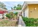 Bright yellow house exterior with walkway and lush landscaping at 335 Pembroke S Ln # 229, Venice, FL 34293