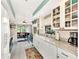 Charming kitchen with white cabinets, granite counters & view to backyard at 335 Pembroke S Ln # 229, Venice, FL 34293