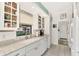 Clean and bright kitchen with white cabinets and granite countertops at 335 Pembroke S Ln # 229, Venice, FL 34293