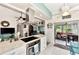 Modern kitchen with island, stainless steel appliances & view to Gathering room at 335 Pembroke S Ln # 229, Venice, FL 34293