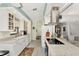 Open concept kitchen boasting white cabinets and granite countertops at 335 Pembroke S Ln # 229, Venice, FL 34293