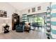 Living area with comfy blue chair and view of screened porch at 335 Pembroke S Ln # 229, Venice, FL 34293