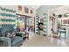 Living room with blue accents and view of kitchen and screened porch at 335 Pembroke S Ln # 229, Venice, FL 34293