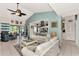 Living room with white couches, blue accents, and view of kitchen at 335 Pembroke S Ln # 229, Venice, FL 34293