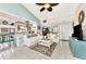 Open living room with white couch, light tile floors, and ceiling fan at 335 Pembroke S Ln # 229, Venice, FL 34293
