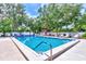 Community pool with lounge chairs and shaded areas at 335 Pembroke S Ln # 229, Venice, FL 34293
