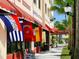 Venice storefront with flags and outdoor seating at 335 Pembroke S Ln # 229, Venice, FL 34293