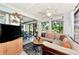 Spacious sunroom with a large sectional sofa and water views at 335 Pembroke S Ln # 229, Venice, FL 34293