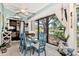 Bright sunroom with water views and a dining table at 335 Pembroke S Ln # 229, Venice, FL 34293