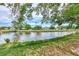 Serene waterfront view with lush greenery and blue skies at 335 Pembroke S Ln # 229, Venice, FL 34293