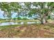 Scenic waterfront view with lush trees and calm waters at 335 Pembroke S Ln # 229, Venice, FL 34293