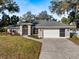 House exterior featuring a two-car garage and landscaping at 337 Flamingo Blvd, Port Charlotte, FL 33954