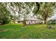 Spacious backyard with lush grass and mature trees at 339 Meadow Beauty Ct, Venice, FL 34293