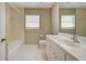 Bathroom with bathtub, toilet, and white vanity at 339 Meadow Beauty Ct, Venice, FL 34293