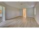Large bedroom with laminate floors and access to a bathroom at 339 Meadow Beauty Ct, Venice, FL 34293