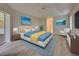 Primary bedroom with laminate wood floor, and stylish decor at 339 Meadow Beauty Ct, Venice, FL 34293