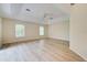 Large bedroom with light walls and wood-look flooring at 339 Meadow Beauty Ct, Venice, FL 34293