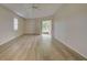 Bright bedroom with laminate flooring and sliding doors to a patio at 339 Meadow Beauty Ct, Venice, FL 34293