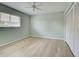 Well-lit bedroom with ceiling fan and laminate floors at 339 Meadow Beauty Ct, Venice, FL 34293